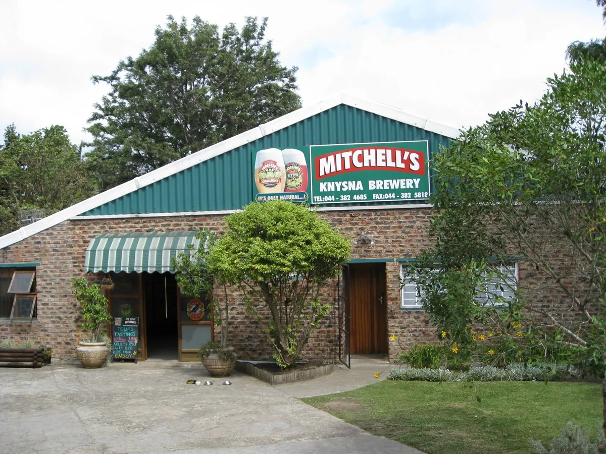 Mitchell's Knysna Brewery — small brick-and-corrugated-iron brewery building with green-and-red signage