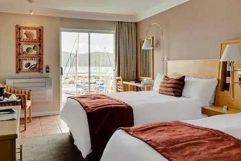 Protea Hotel Knysna Quays twin room with sliding door open to a marina-facing balcony
