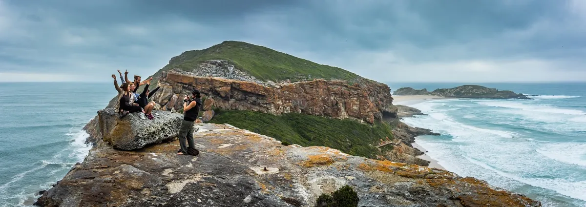 Robberg Peninsula clifftop viewpoint with hikers above Plettenberg Bay, Garden Route