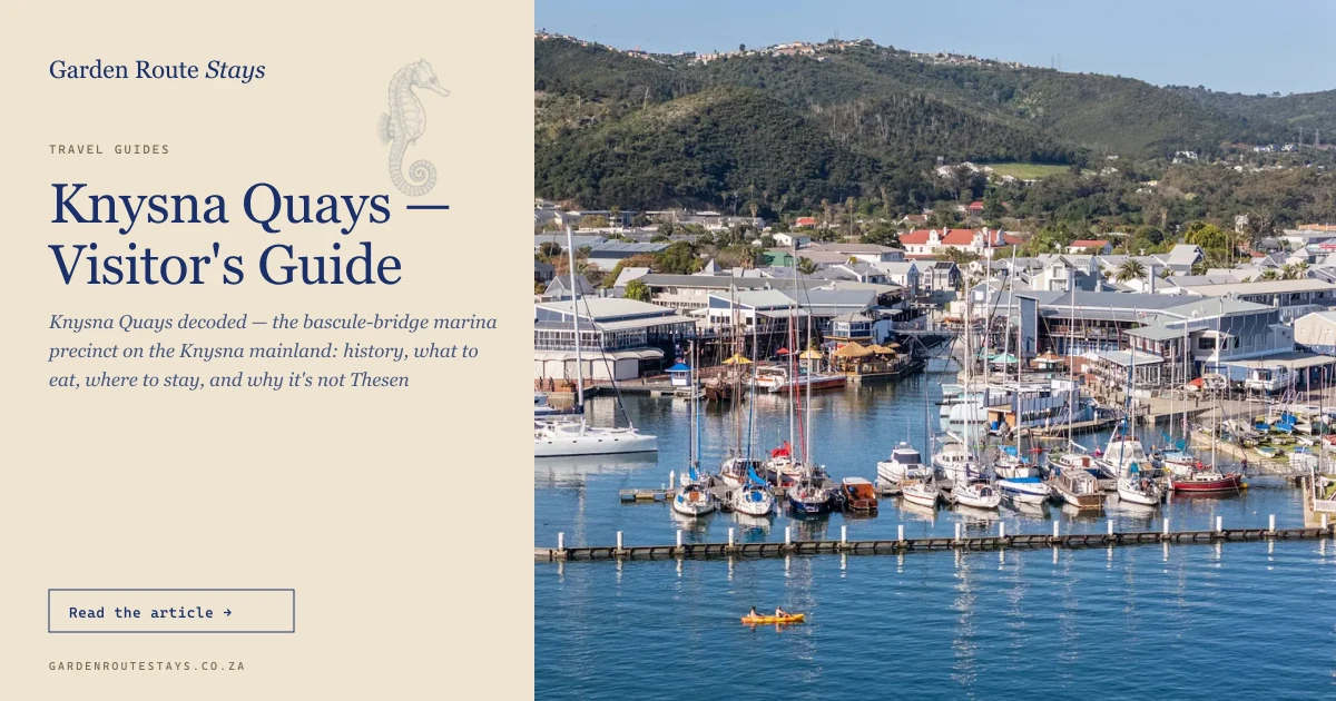 Knysna Quays from above — yachts moored along the marina pontoons with the lagoon and town beyond