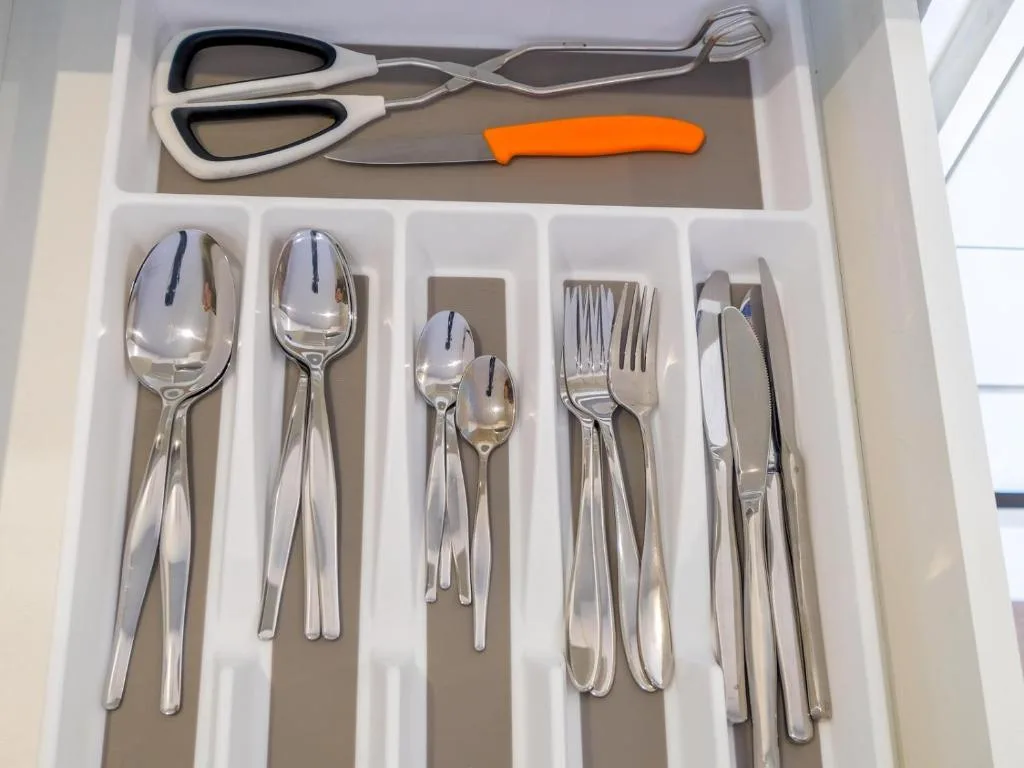Kitchen drawer with organized silverware and serving utensils