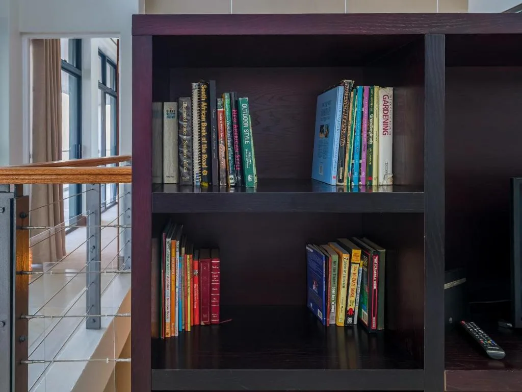 Dark wooden bookshelf filled with colorful books and literature collection