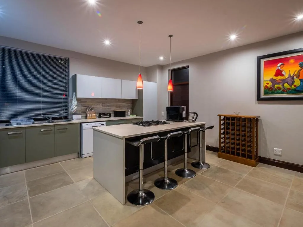 Modern kitchen with island counter, gas stove, and seating for three