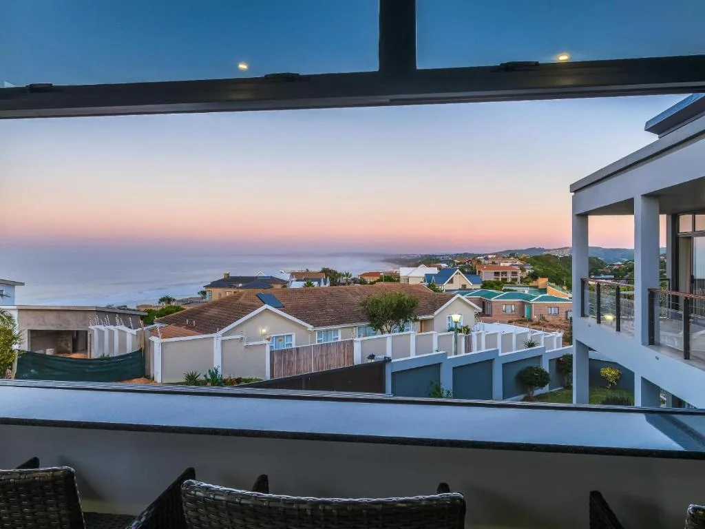 Coastal sunset view over Great Brak River with neighboring homes and ocean horizon