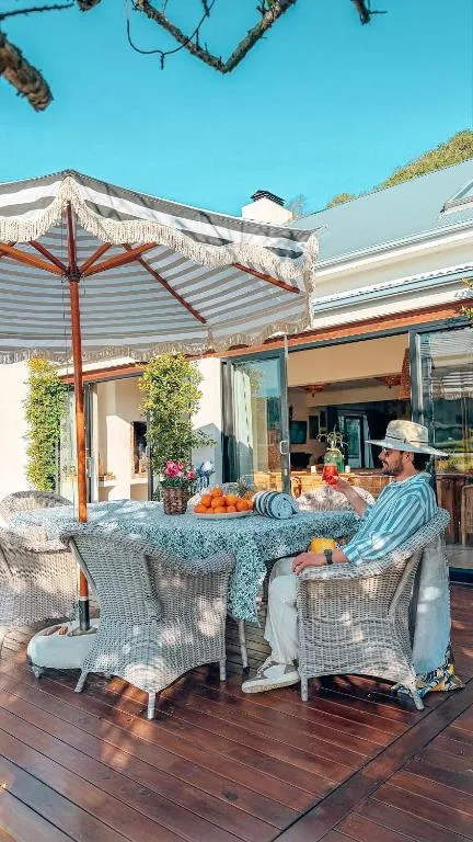 Shaded outdoor deck with seating, umbrellas, and mountain views