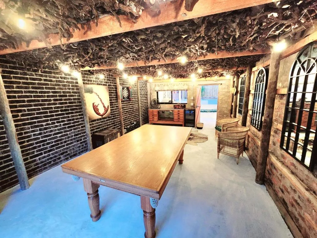 Rustic interior space with dining table, brick walls, and decorative lighting