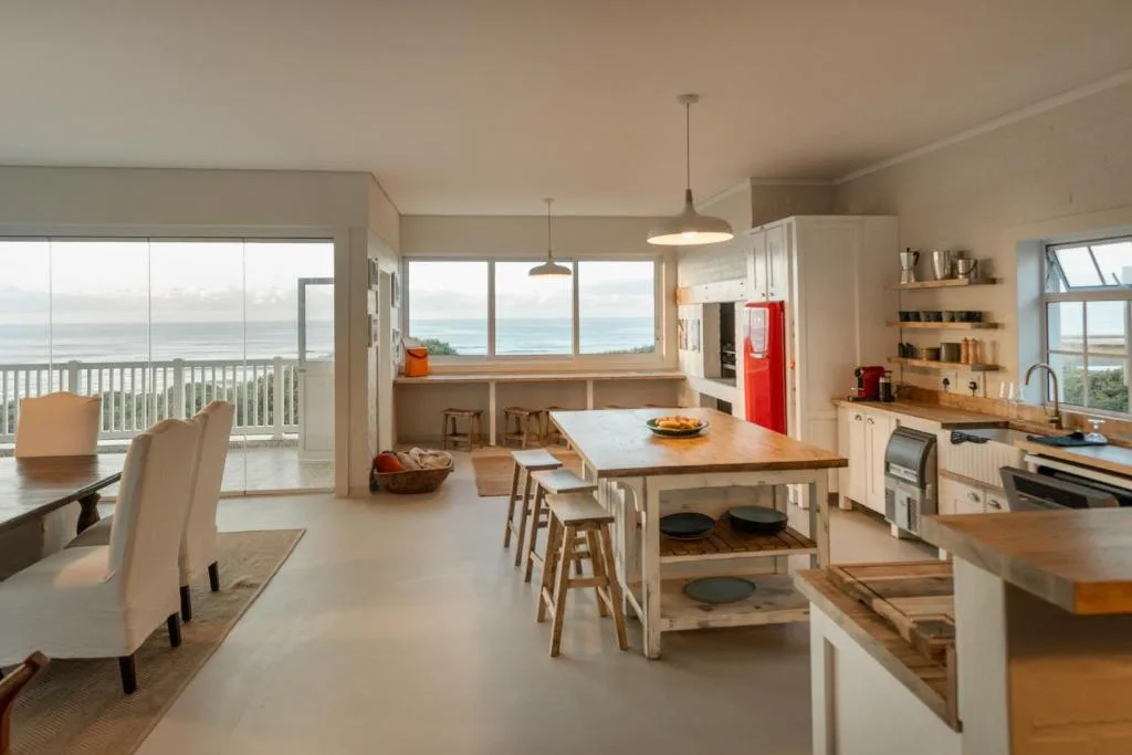 Modern open-plan kitchen with ocean views and dining island