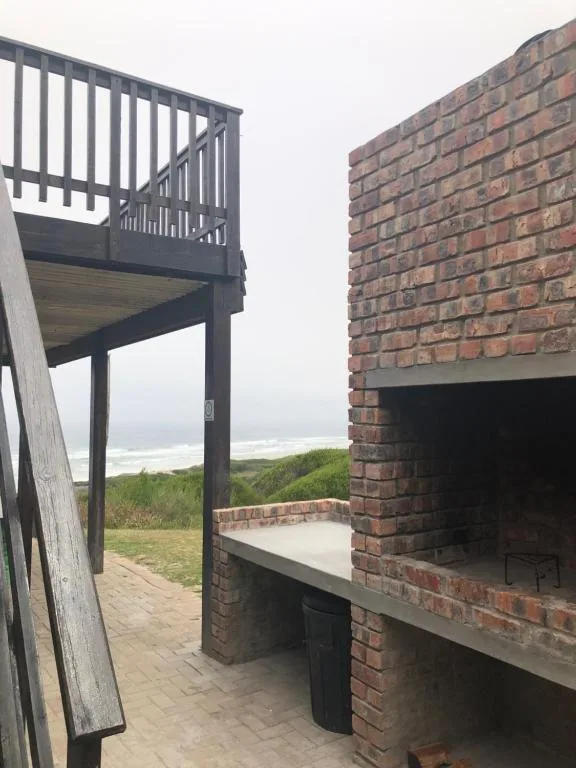 Elevated deck with ocean view and built-in brick braai area