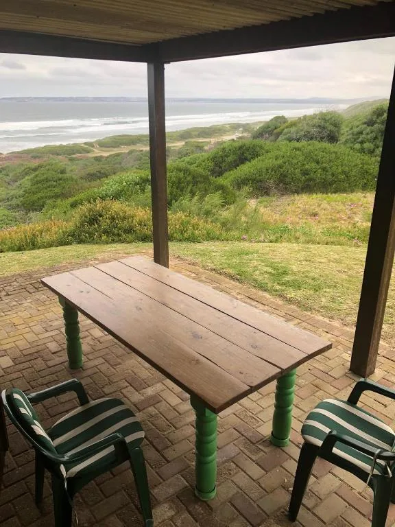 Covered outdoor dining area with ocean and coastal views