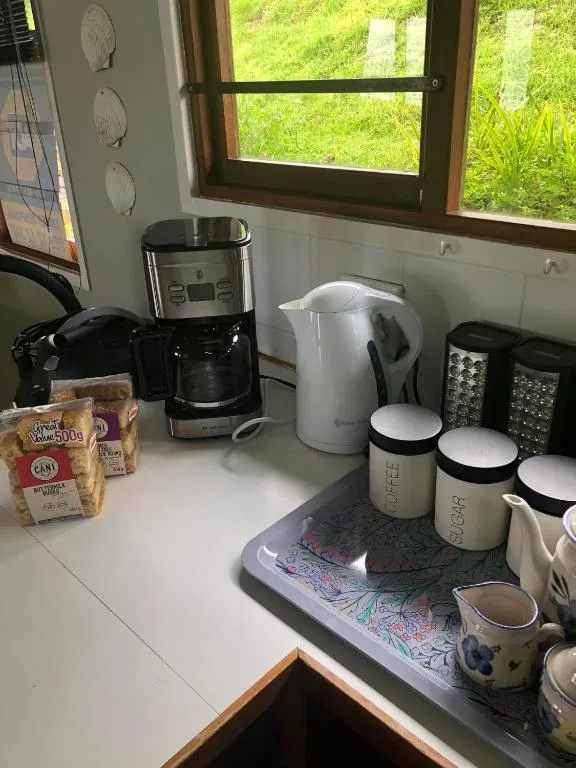 Kitchen counter with coffee maker, kettle, and decorative storage containers