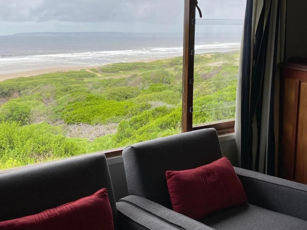 Panoramic coastal ocean and beach view from comfortable lounge seating