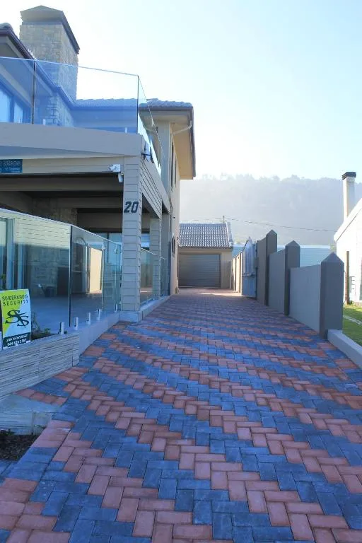 Modern home entrance with patterned brick driveway and mountains beyond