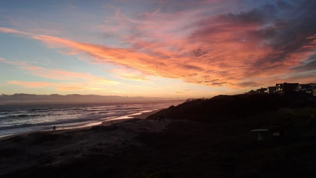 Stunning sunset over the ocean with dramatic pink and orange sky