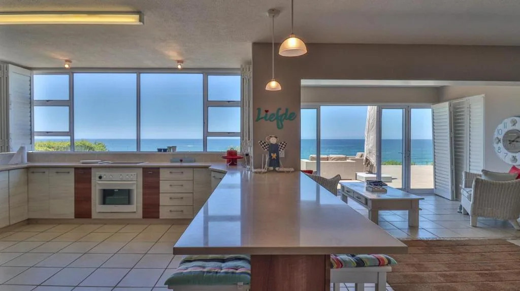 Modern kitchen with ocean views, island counter, and coastal decor