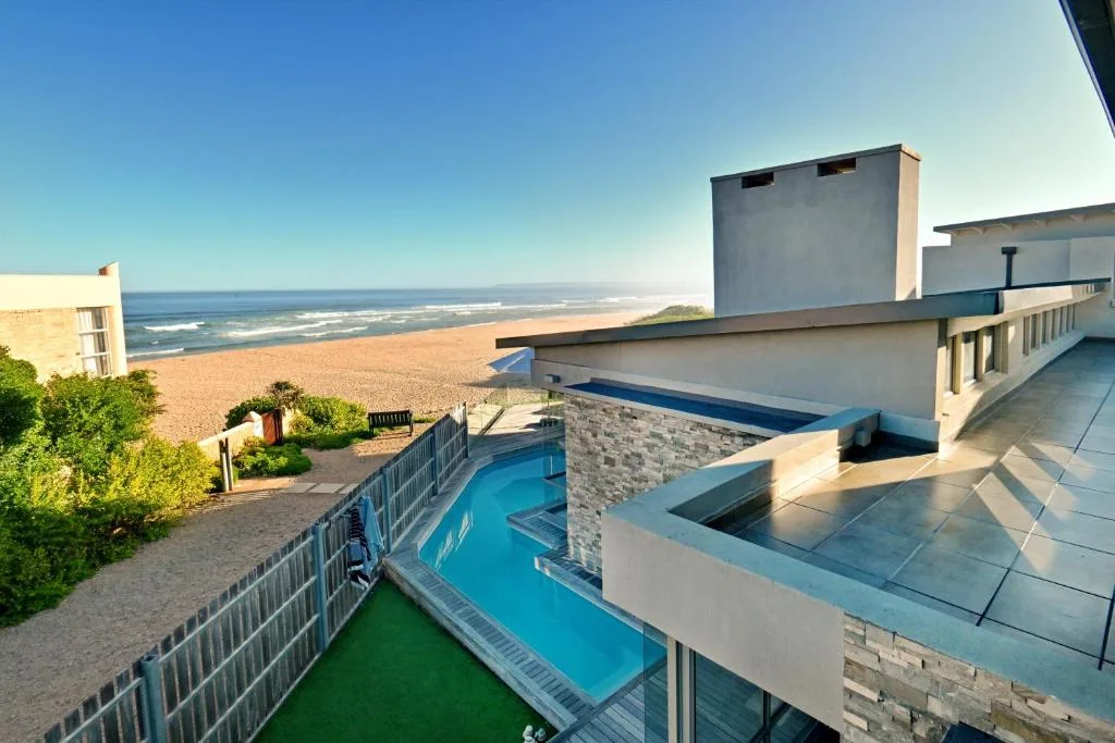 Heated swimming pool overlooking pristine beach and ocean coastline