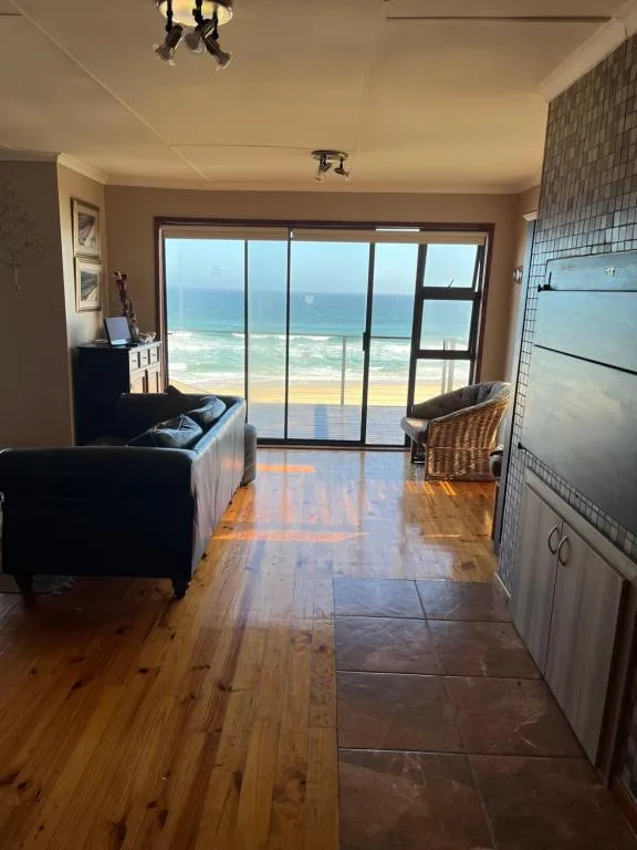 Expansive ocean and beach vista through large sliding glass doors