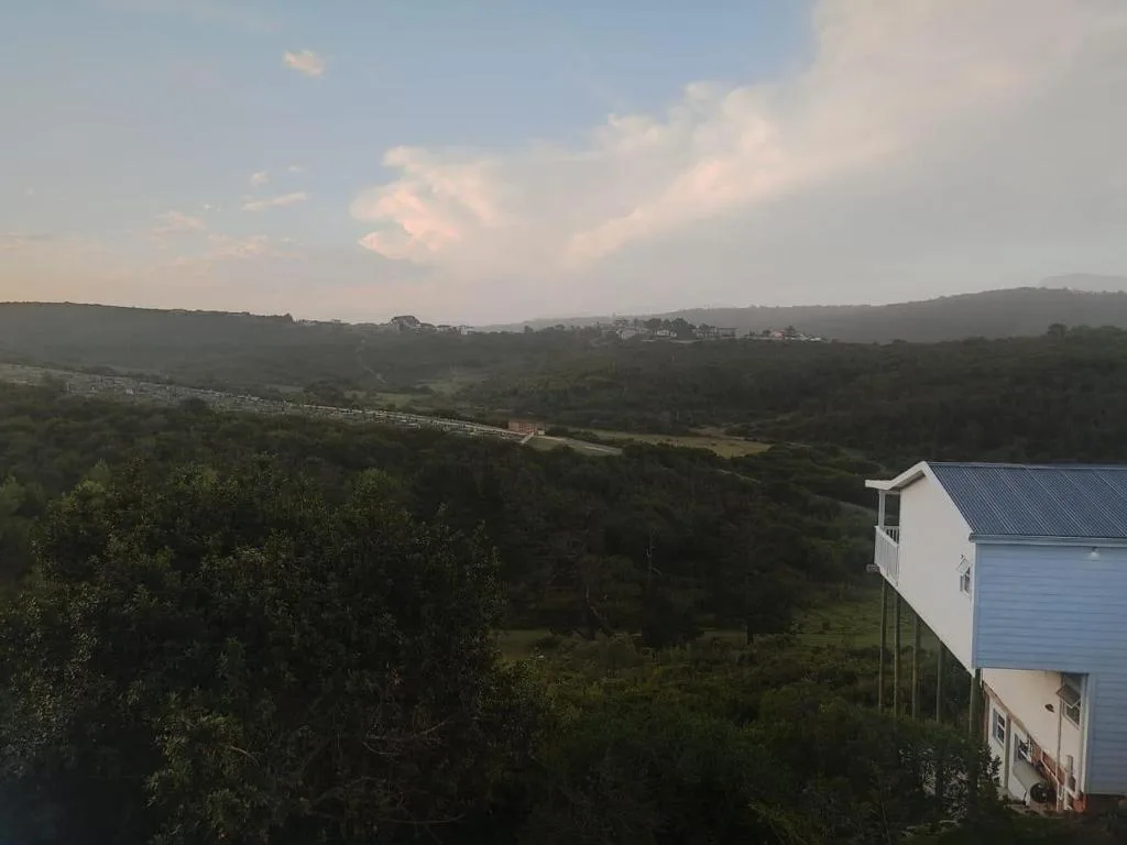 Scenic valley landscape with green hills and distant properties