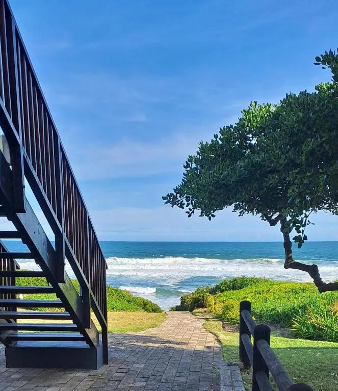 Ocean view with beach and waves from beachfront property deck