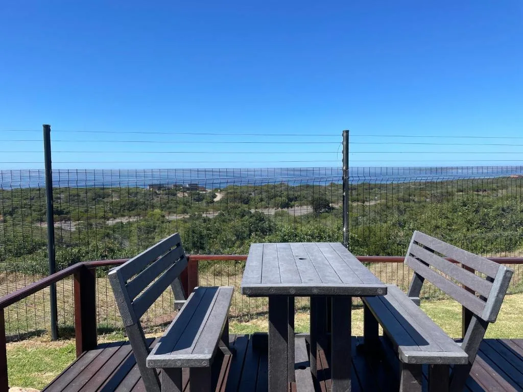 Scenic coastal view from elevated deck with ocean and vegetation visible