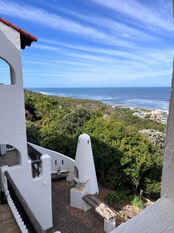 Expansive ocean and coastal forest vista from elevated property deck