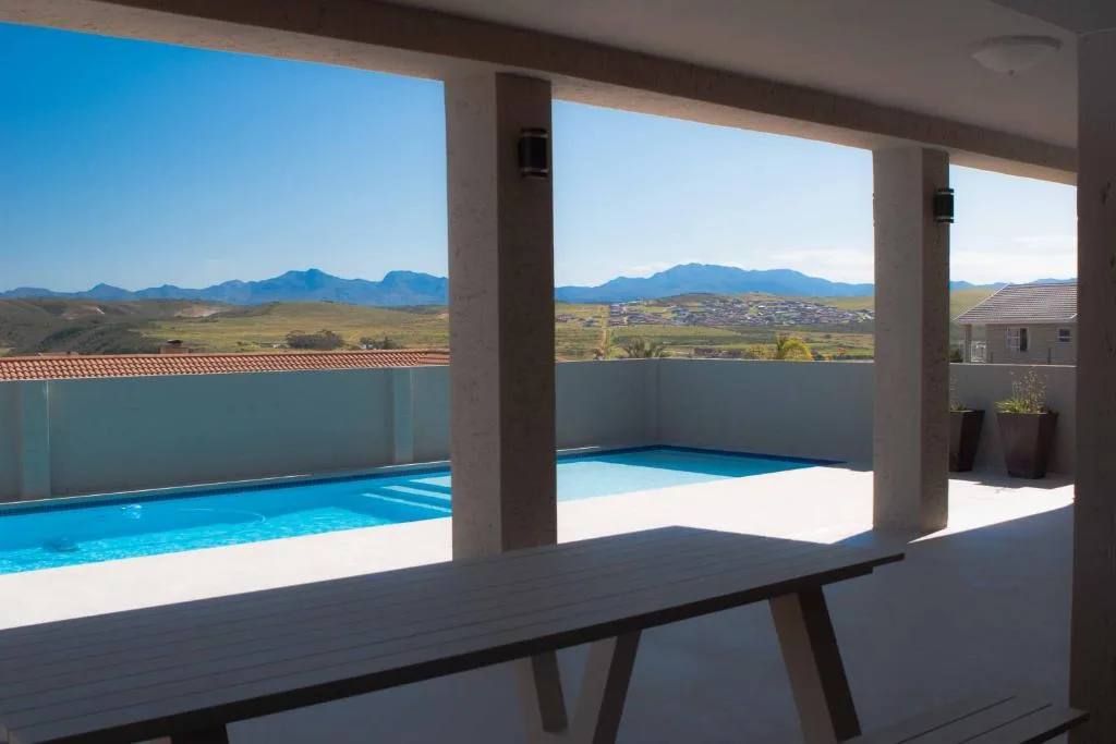 Mountain landscape and valley vista through covered poolside pavilion windows