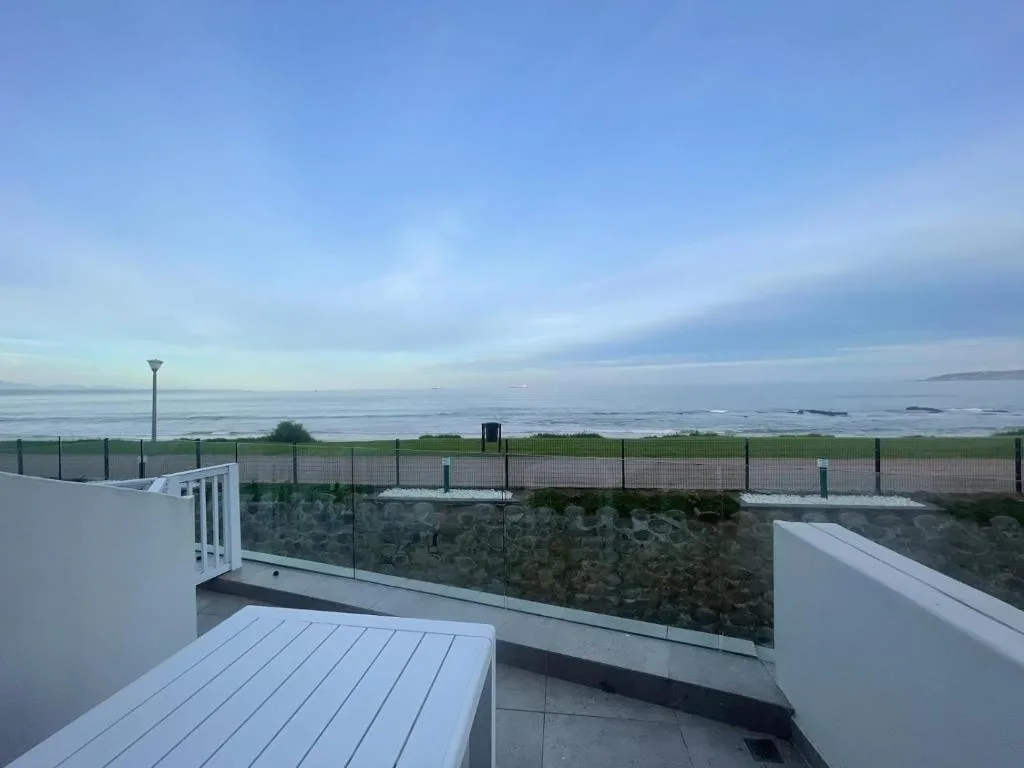 Ocean and lagoon vista from elevated deck with clear skies