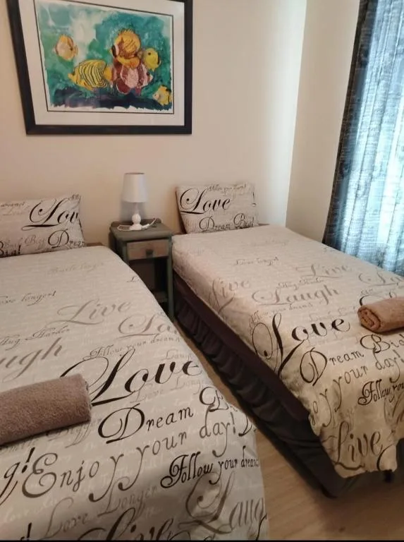 Twin bedroom with inspirational quote bedding and framed fish artwork