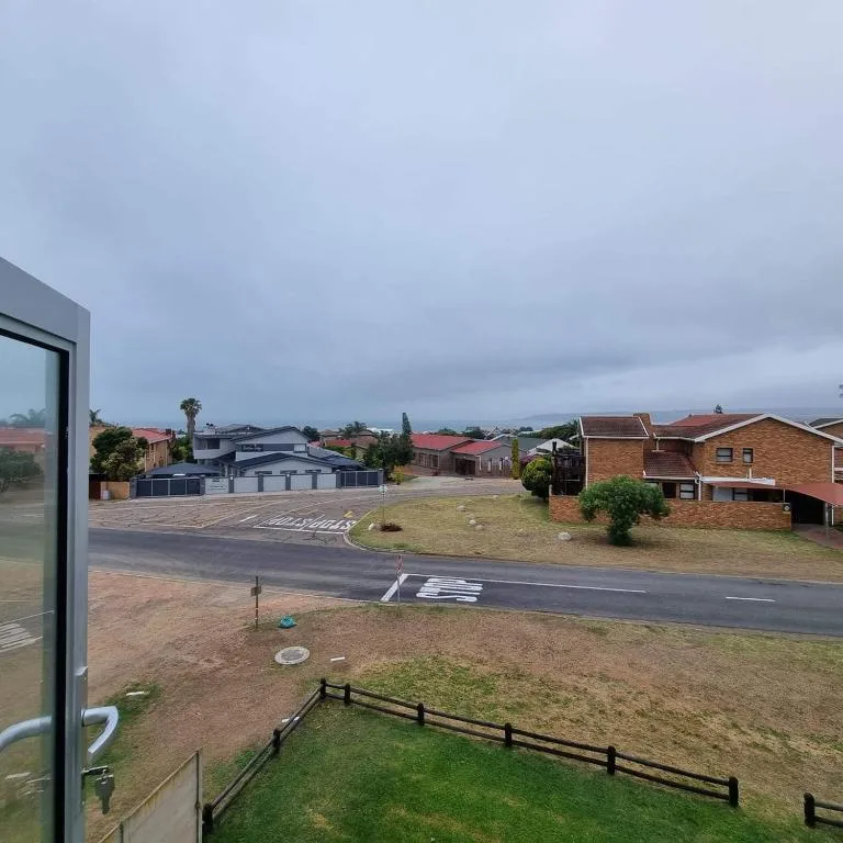 Suburban street view with residential homes and distant mountains