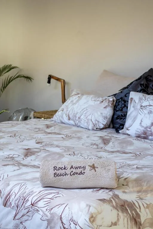 Cozy bedroom with patterned bedding, decorative pillows, and potted plant
