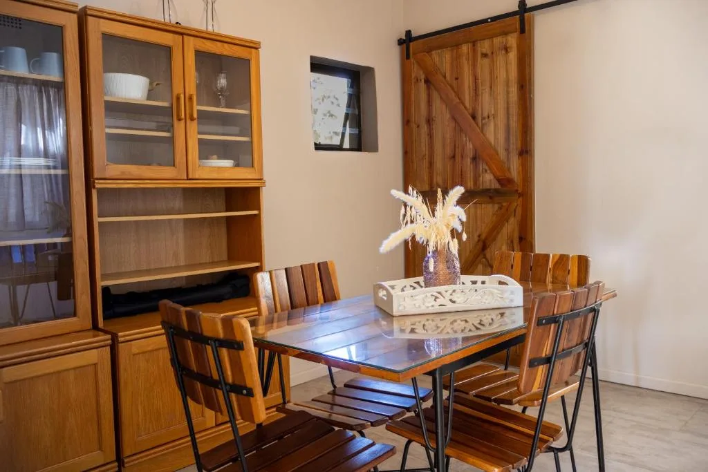 Modern dining table with wooden chairs and built-in cabinetry