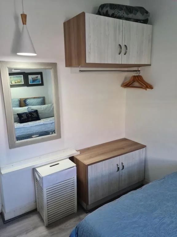 Modern bedroom with built-in storage, window, pendant light fixture