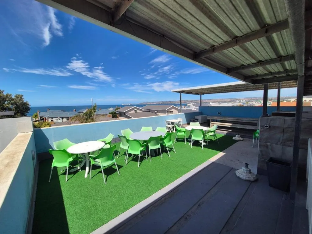 Rooftop deck with green furniture, ocean views, and braai facilities