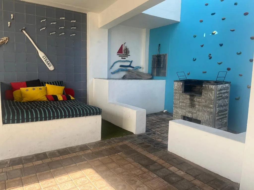 Colorful themed bedroom with nautical decor and climbing wall feature
