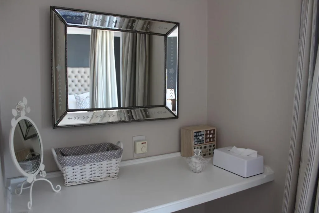 Modern bathroom vanity with framed mirror and decorative accessories