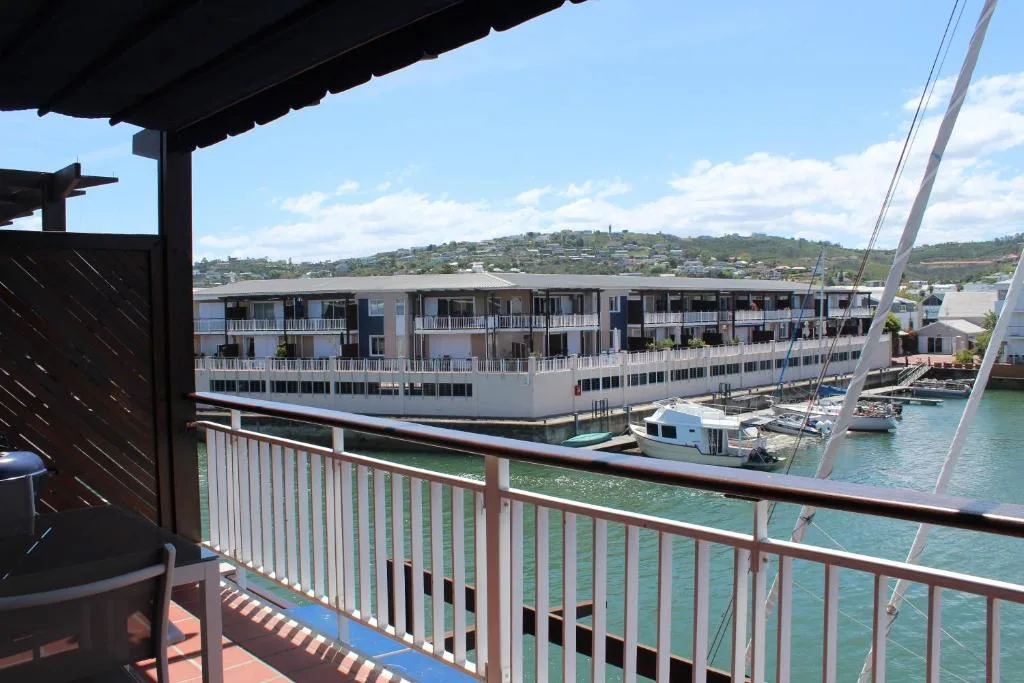 Waterfront view of Knysna Lagoon with boats and residential buildings