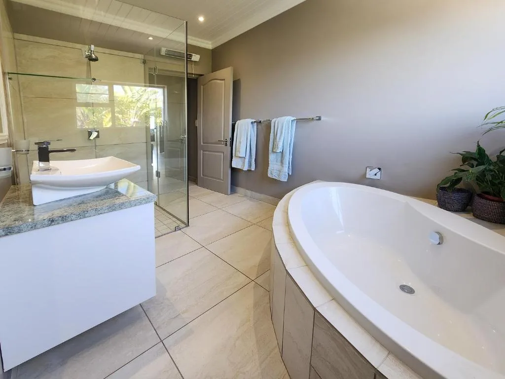 Spacious bathroom with freestanding bathtub, walk-in shower, and double vanity