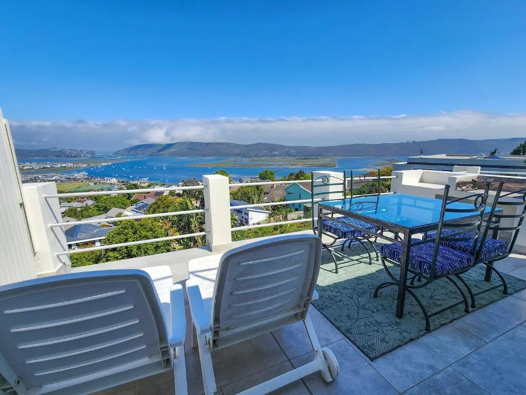 Expansive rooftop deck with loungers overlooking Knysna lagoon and mountains