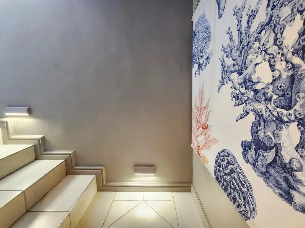 Staircase with decorative blue and white botanical wall tapestry