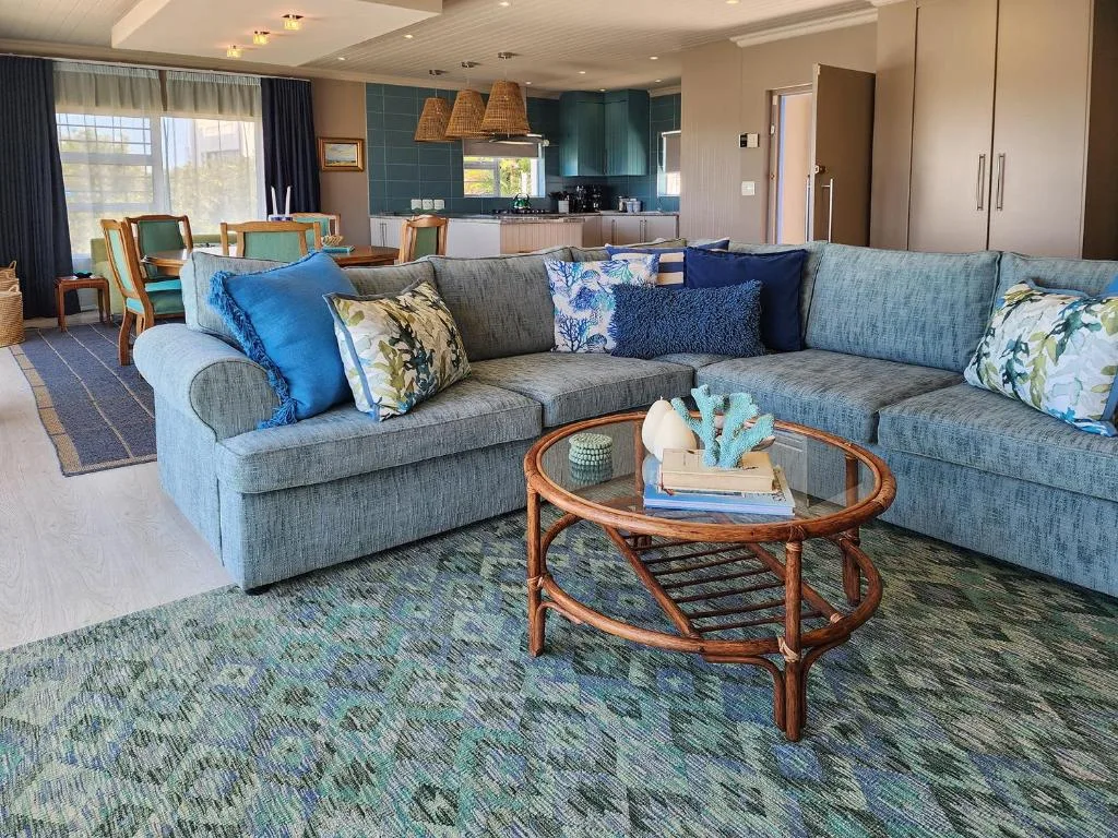 Spacious living room with gray sectional sofa and wooden coffee table