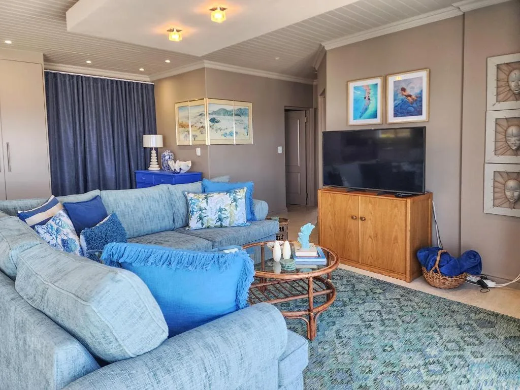 Contemporary living room with blue upholstered seating and flat-screen television