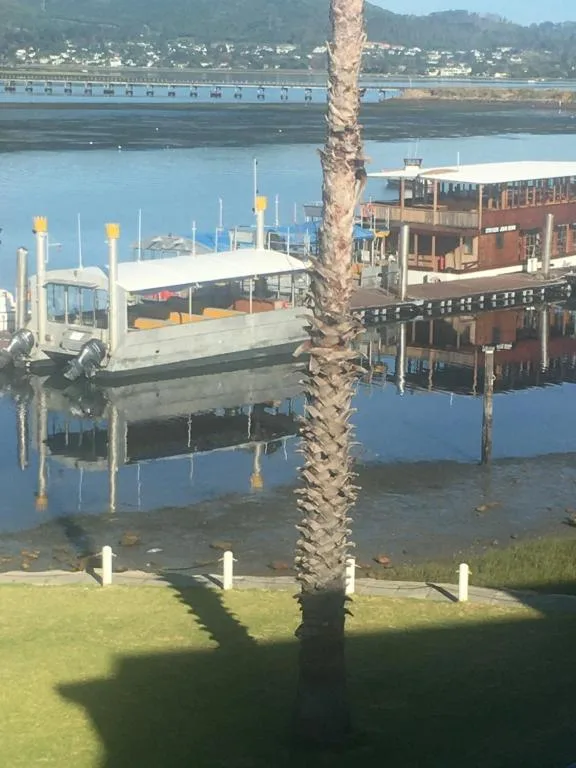 Knysna Lagoon waterfront view with moored boats and mountains beyond