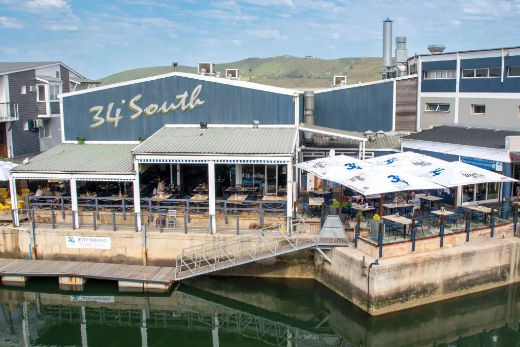 Waterfront restaurant and bar with covered seating areas overlooking lagoon