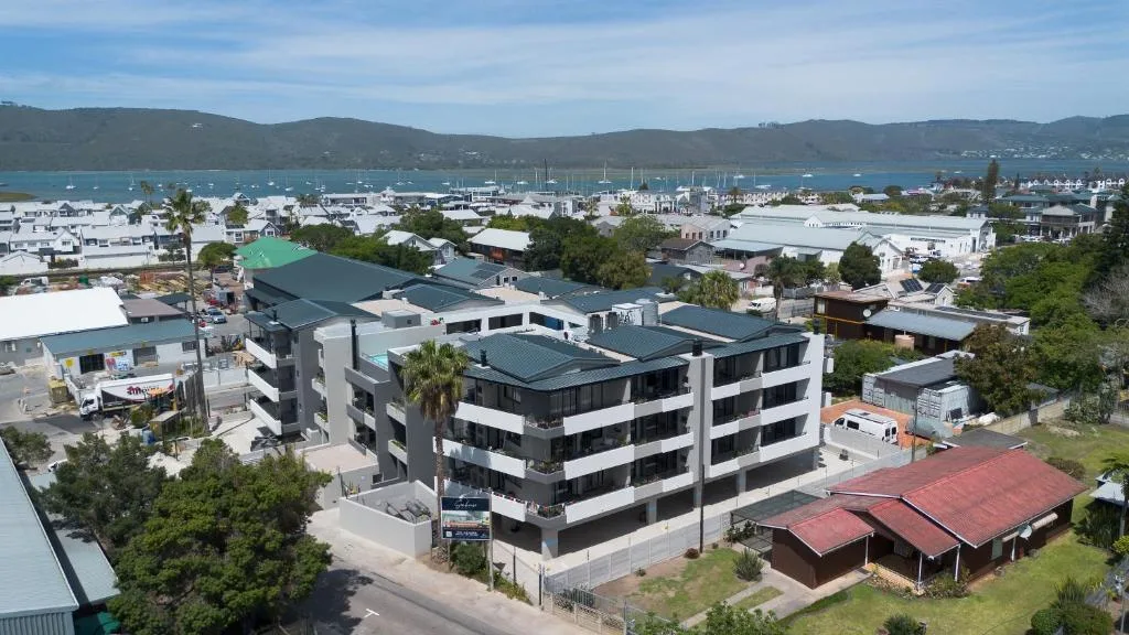 Modern multi-story apartment building overlooking Knysna marina and mountains