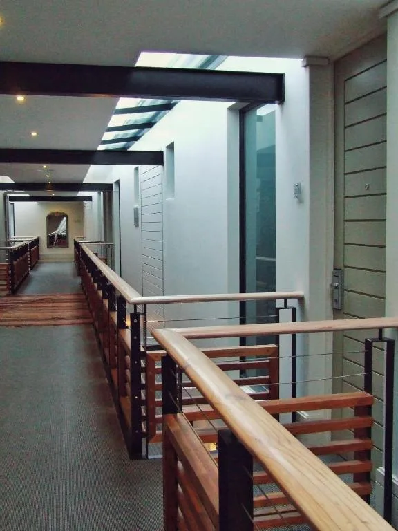 Modern interior hallway with wooden railings and skylight features