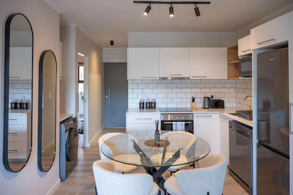 Modern kitchen with white cabinetry, subway tile backsplash, and stainless steel appliances