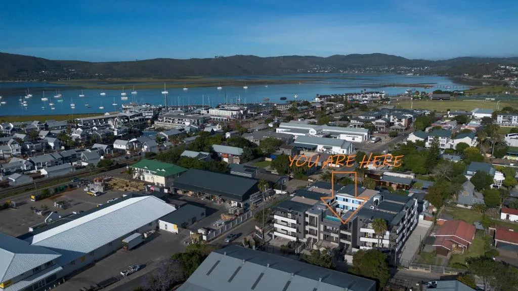 Aerial view of Knysna lagoon with moored boats and coastal town