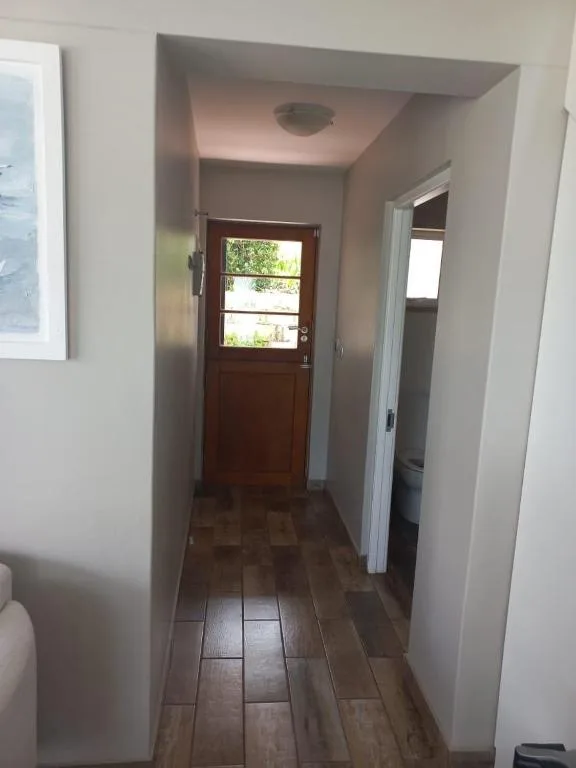 Interior hallway with wooden door and tiled flooring