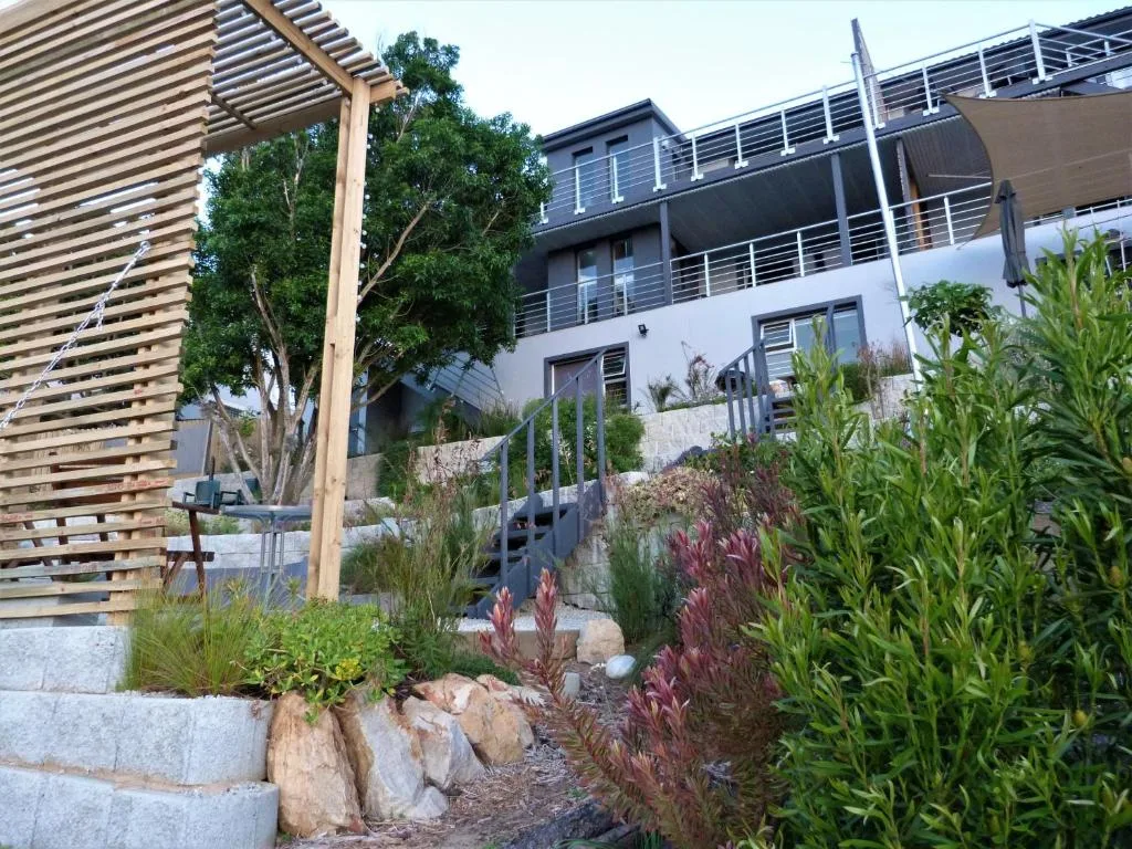 Modern multi-level holiday home with landscaped gardens and wooden pergola