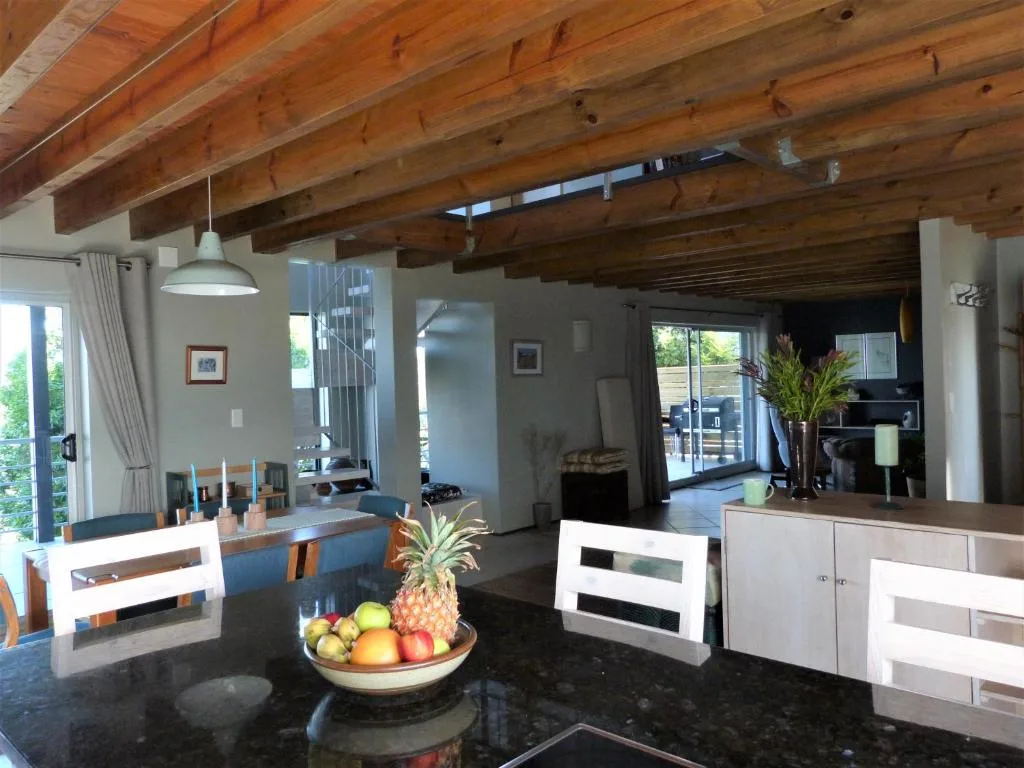 Open-plan living area with exposed wooden beams and modern furnishings