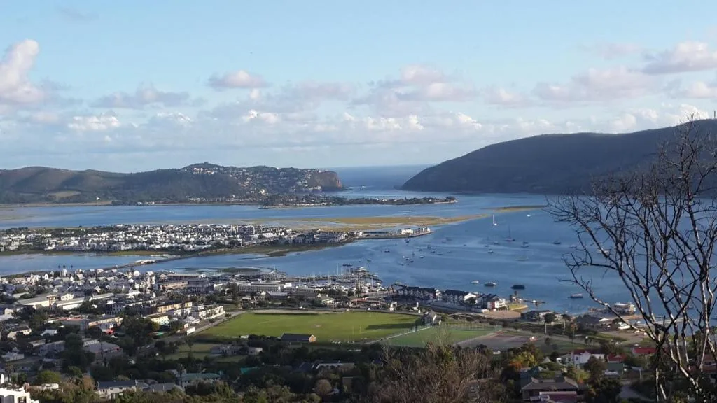 Panoramic view of Knysna Heads, lagoon, and surrounding coastal mountains from hillside